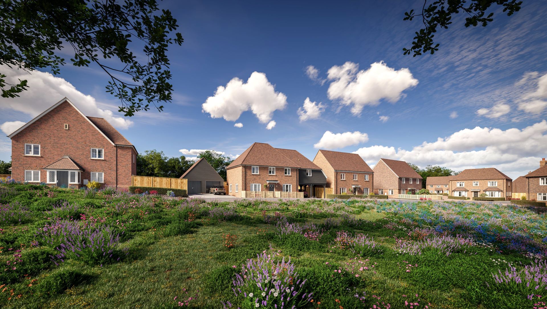 A row of large modern brick houses behind a patch of grass that has flowers and plants on it